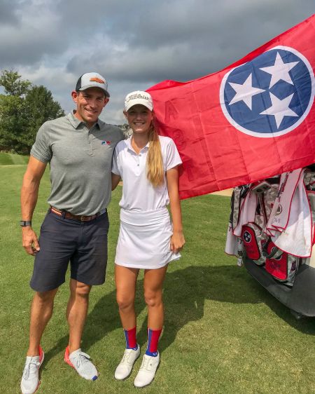 Scott Stallings in a grey t-shirt poses with wife Jennifer White.